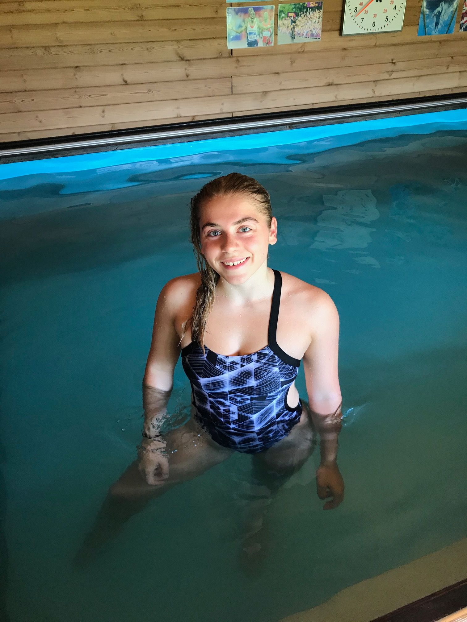 swimmer standing in pool looking up