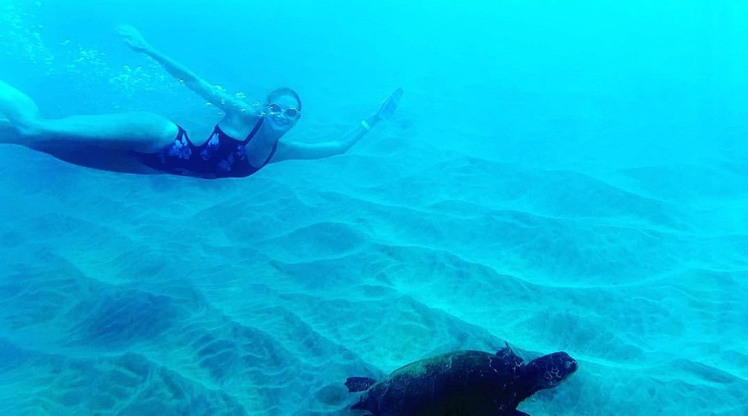 swimmer underwater with a turtle