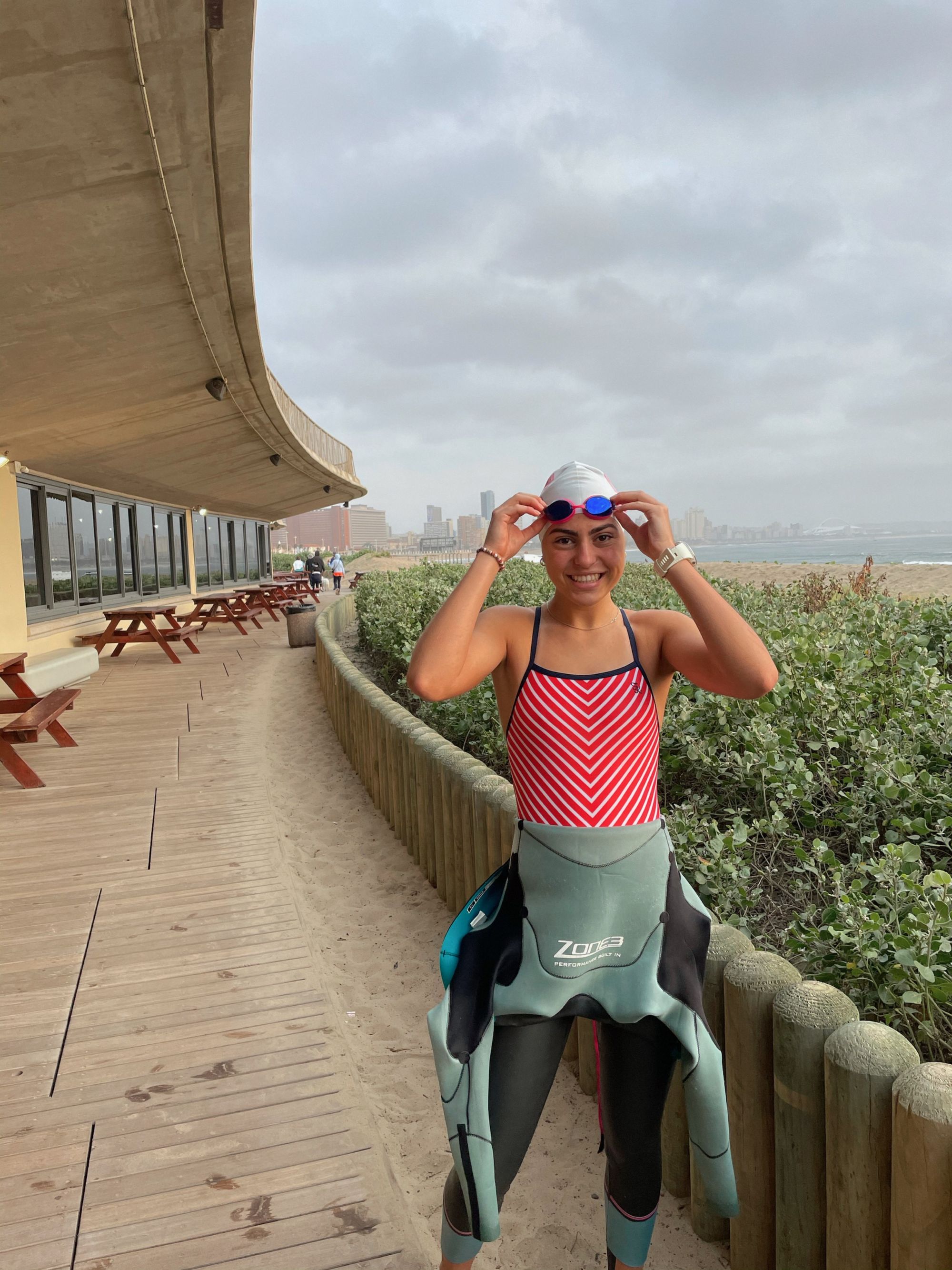 athlete adjusting goggles in a wetsuit