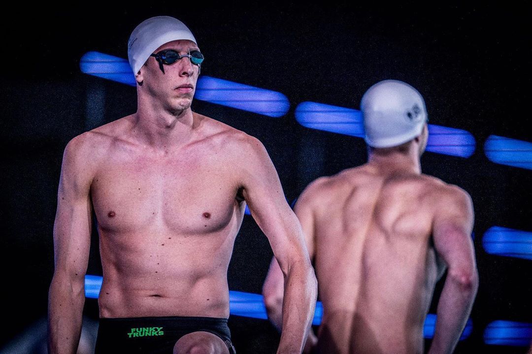swim racer with cap and goggles ready to race