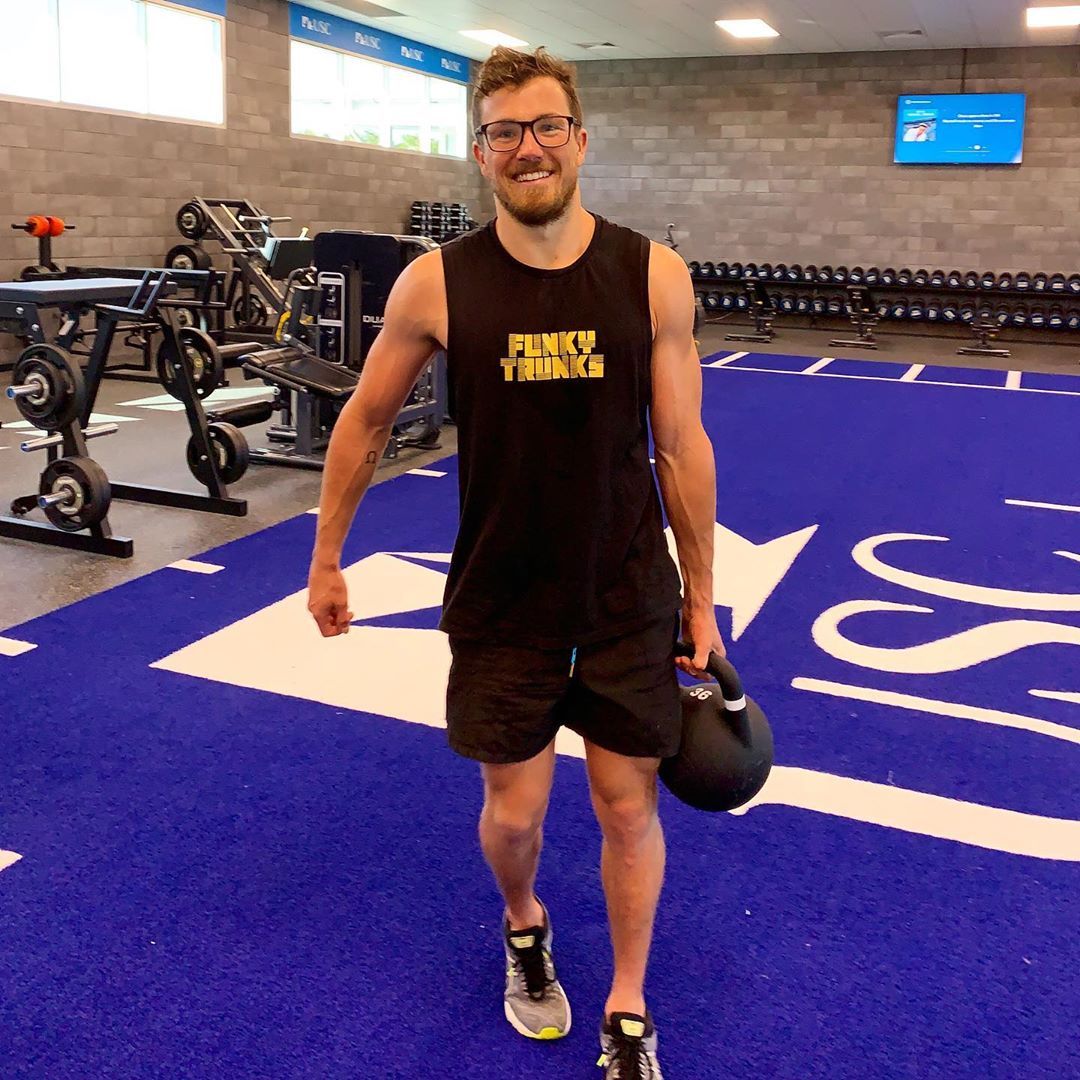athlete holding weight in the gym